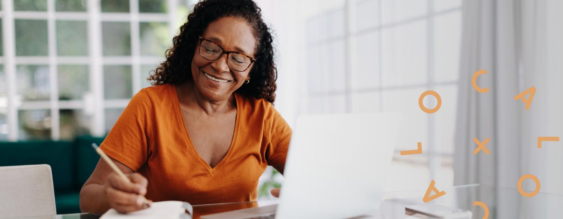 a person smiling and sitting at a table