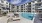 pool area with reclining seats and landscaping